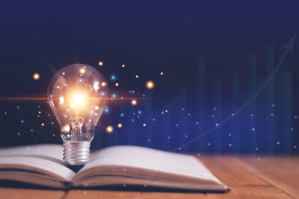 Ampoule allumée dans un livre diffusant des points lumineux reliés entre eux, symbolisant la connaissance et la compréhension des enjeux énergétiques.